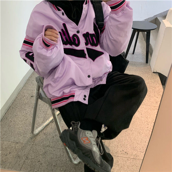 Woman wearing loose hip hop jacket with letter print
