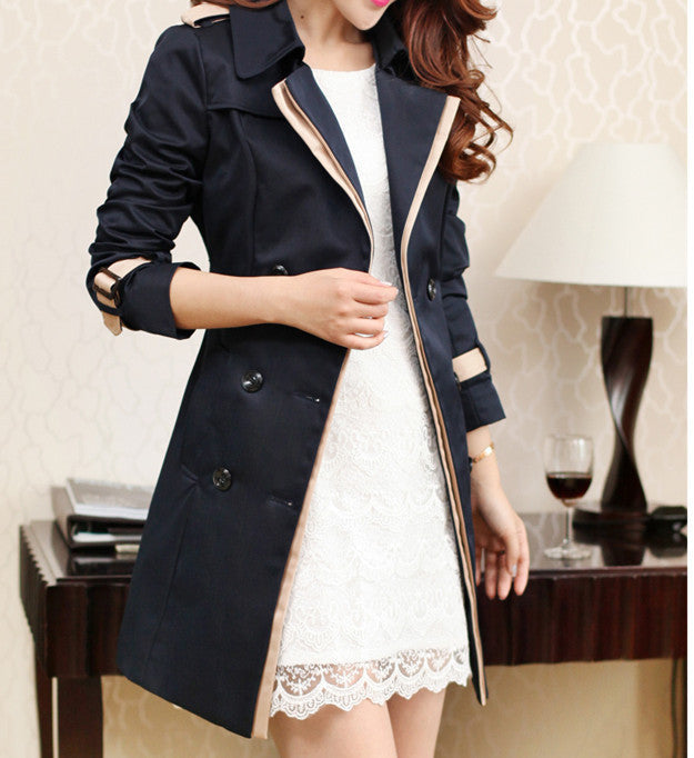 Woman wearing long black trench coat with long sleeves