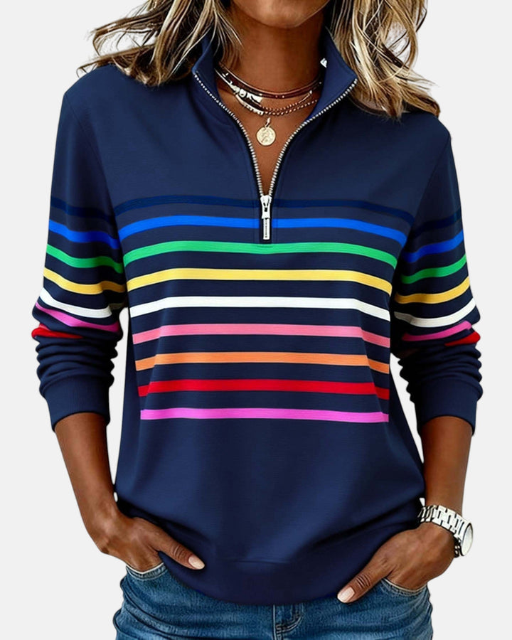 Woman wearing rainbow striped half zip sweatshirt