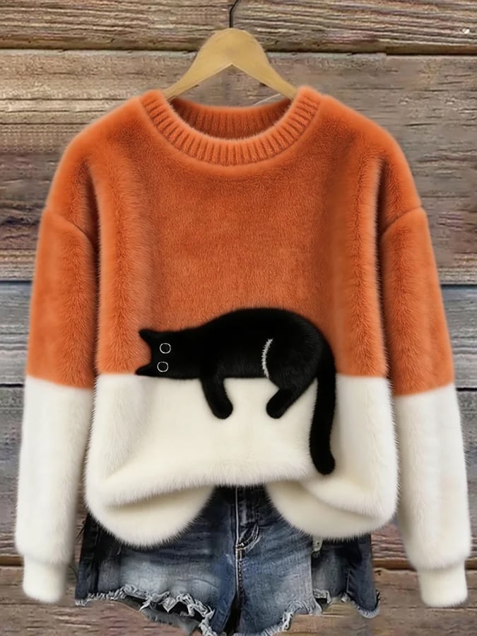 Woman wearing cat print knit sweater, relaxed fit